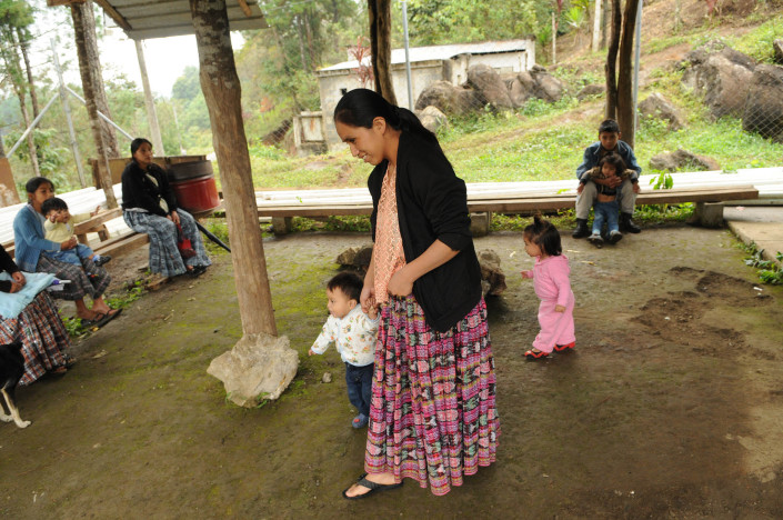 An indigenous Mayan woman leaves a health centre in rural Guatemala, where she has just had her children immunized.