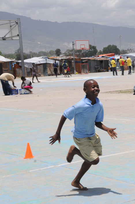 A boy participates in organized games at Carrefour Aviation, a tent camp housing 50,000 people who were displaced by the 7.3 magnitude earthquake on 12 January in Haiti.
