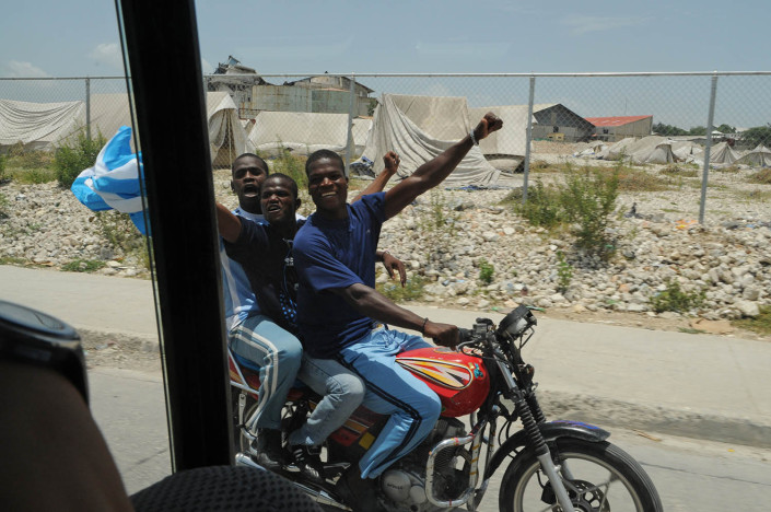 Fans ride alongside the convoy of Footballer and UNICEF Goodwill Ambassador Lionel 'Leo' Messi in Port-au-Prince, Haiti.