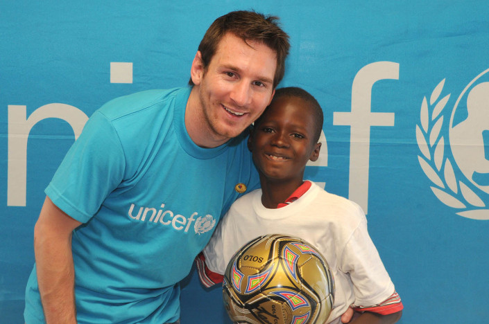 UNICEF Goodwill Ambassador Lionel ‘Leo’ Messi stands with 12-year-old Rikelme Marseil, who is holding a football, at the UNICEF office in Port-au-Prince, Haiti.