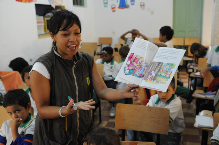 A first-grade teacher reads to her students in Medellín, Colombia.