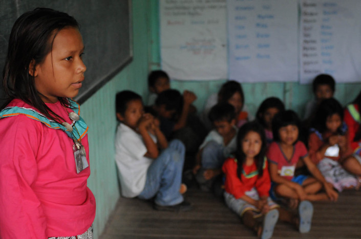 A girl stands inside a classroom in the indigenous Shipibo-Conibo community of Nuevo Saposoa in the Peruvian Amazon.
