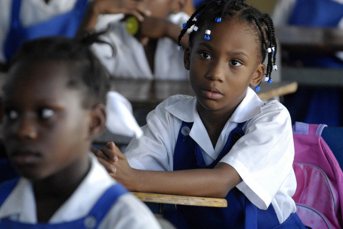 Girls listen to a discussion at a primary school in Jamaica.
