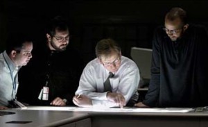 (L-R) Star-Ledger Photographers Aristede Economopoulos and Tony Kurdzuk discuss images with Star-Ledger Director of Photography Pim VanHemmen and Feature Photo Editor Lucius Riley over the photo department's light table. ©Amanda Brown/The Star-Ledger