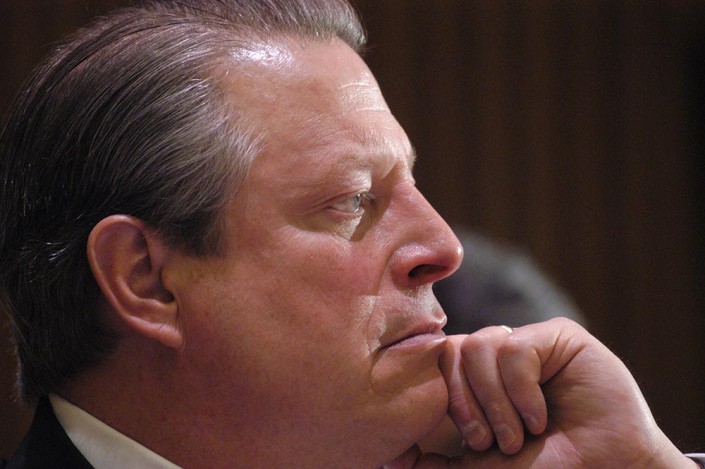 Al Gore looking serious while listening to a speaker at the UN.