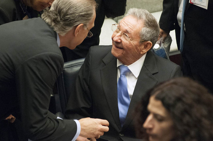 Cuban President Raul Castro smiles at a fellow diplomat as they chat at the UN.