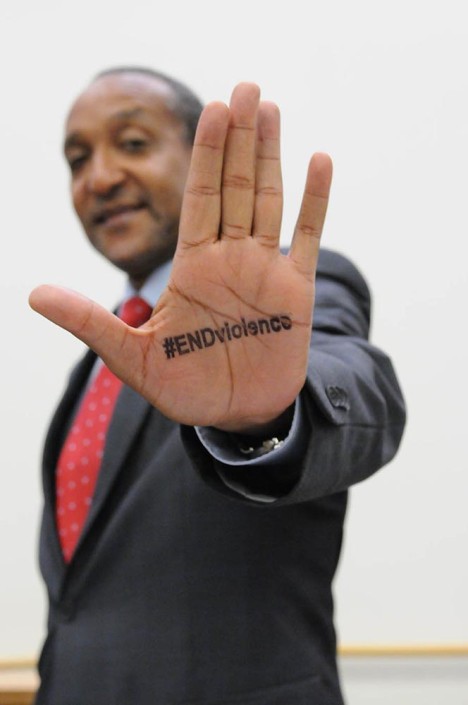 Permanent Representative of Kenya to the UN, Macharia Kamau shows the hashtag END Violence, stamped on his hand.