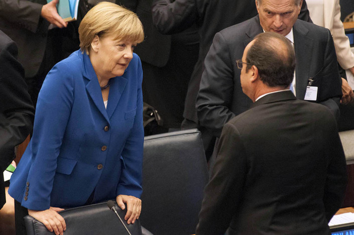 German Chancellor Angela Merkel speaks informally with French President Francois Hollande at the UN.