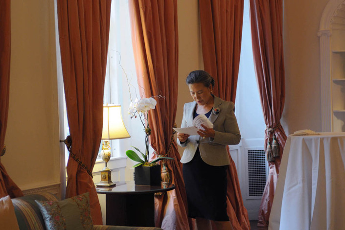 Portrait of Mrs. Ban Ki-moon reads next to a window in the elegant living room of the United Nations official residence.