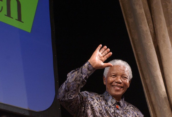 A smiling Nelson Mandela, waves to children at the Manhattan Center in New York City.