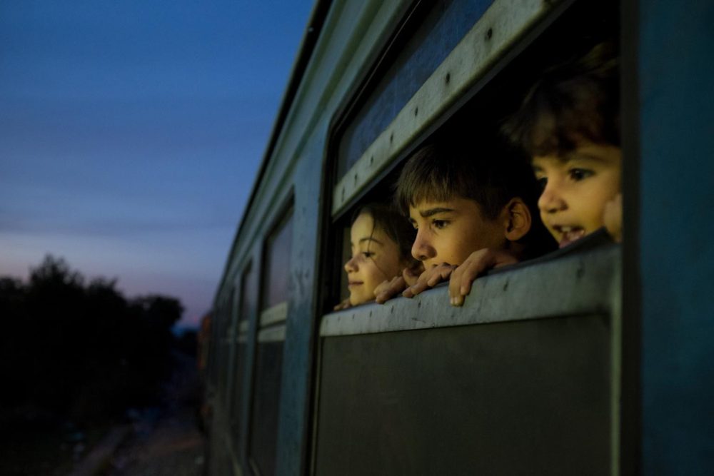 Children peeking out a train