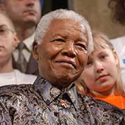 Nelson Mandela is surrounded by children at a United Nations children's forum