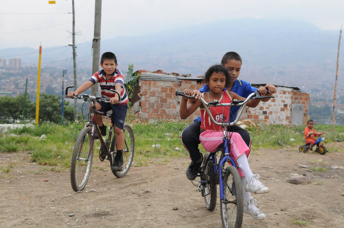 Children ride bikes near their homes on a toxic landfill known as El Morro in a poor neighborhood in Medellin, Colombia.