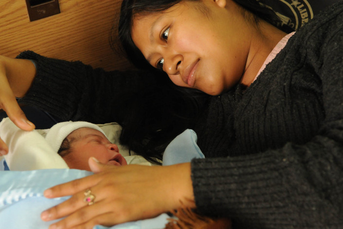 An indigenous Mayan woman cradles her newborn son at Coban Hospital in Guatemala.