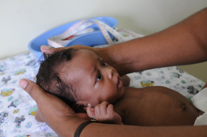 A nurse examines a six-week-old baby's fontanel (soft spot) during a check-up in a health centre in the Grants Pen community of Kingston and St. Andrew, Jamaica.