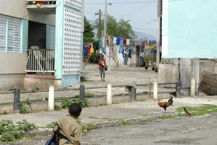 A boy walks home from school as another boy walks toward him in Rema, Kingston, Jamaica.
