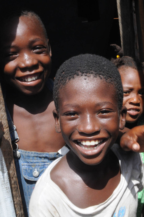 Displaced children smile in Carrefour Aviation after the 2010 Haiti earthquake.