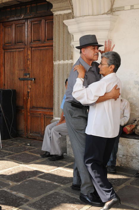 A couple dances in a plaza in Antigua, Guatemala.