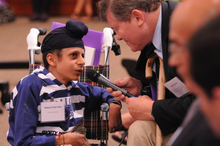 A child delegate addresses a disabilities conference