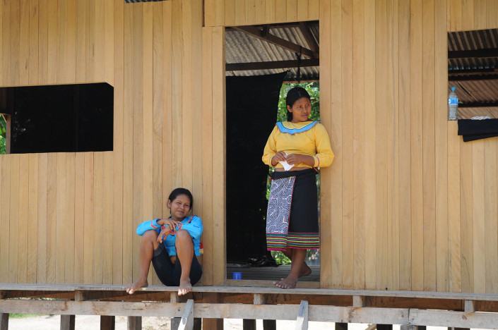 A mother and daughter chat outside their home in the indigenous Shipibo-Conibo community of Nuevo Saposoa in the Peruvian Amazon.