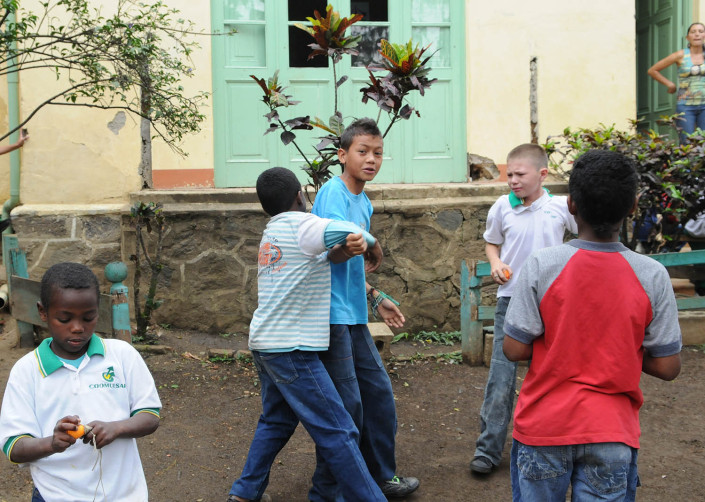 A boy bullies another outside a school in Colombia.