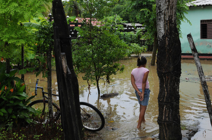 A girl walks through her flooded yard in northern Colombia.