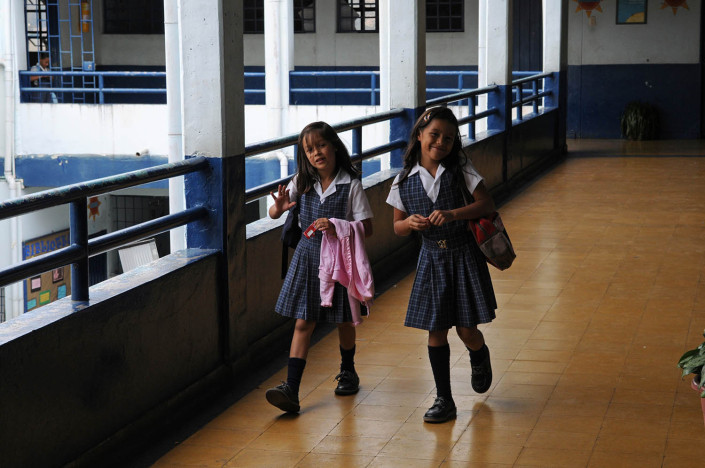 Girls walk through the hallways of a school in Medellín, Colombia.