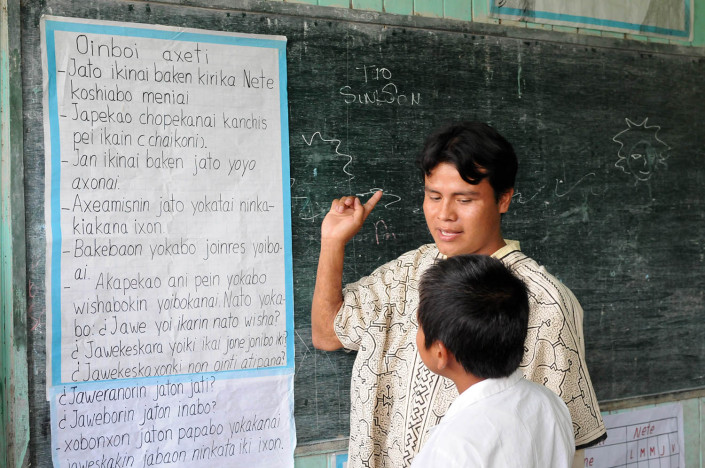 A teacher instructs a student in Shipibo, in the indigenous Shipibo-Conibo community of Nuevo Saposoa in the Peruvian Amazon.