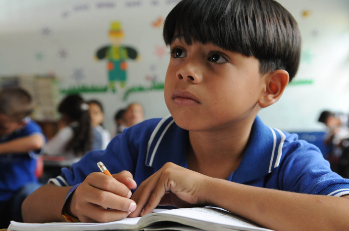 A boy studies during a second-grade Spanish class near Medellin, Colombia.