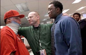 Star-Ledger Photographer Matt Rainey (center) embraces (L-R) Alvaro Llanos and Shawn Simons, after winning the 2000 Pulitzer Prize in Feature Photography for a story about the two Seton Hall students who recovered from a fire in their dorm. Photo by Saed Hindash/The Star-Ledger