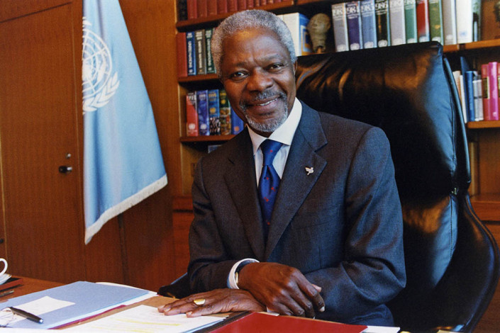 A smiling UN Secretary-General Kofi Annan sits in his office at UN headquarters following the 2011 Nobel Peace Prize announcement.
