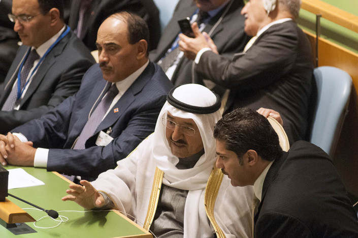 The Amir of Kuwait consults with a colleague in the UN General Assembly.