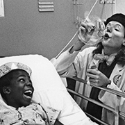 A young patient is entertained by the Clown Care Unit of the Big Apple Circus in his hospital room.
